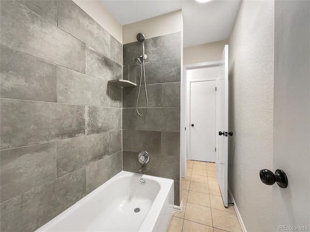 bathroom featuring tile patterned floors and tiled shower / bath