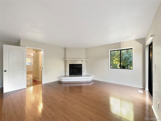 unfurnished living room with hardwood / wood-style flooring