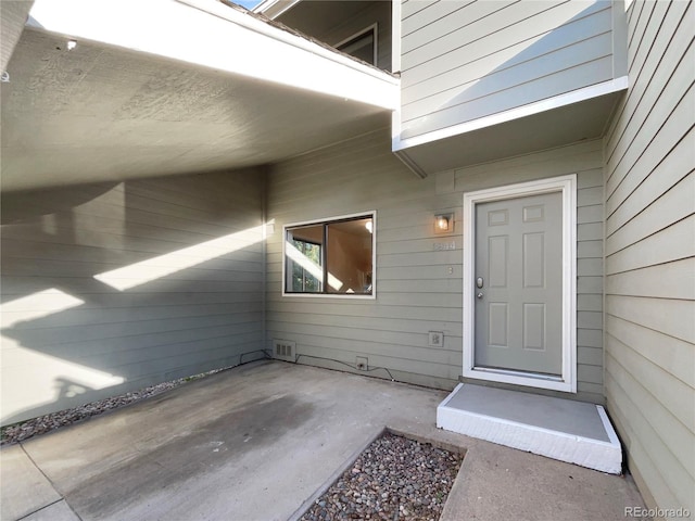 entrance to property with a patio