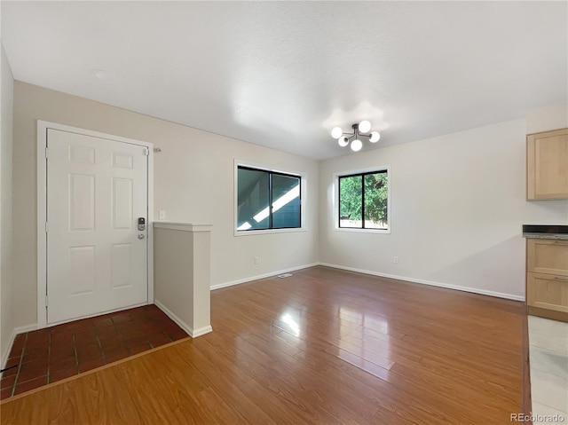 interior space featuring a chandelier and dark wood-type flooring