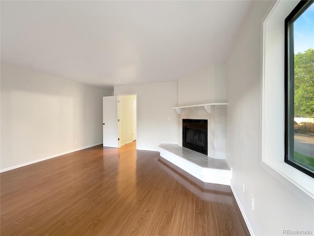 unfurnished living room with a fireplace and wood-type flooring