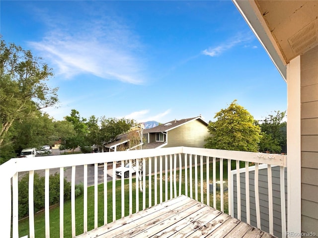 wooden deck featuring a yard