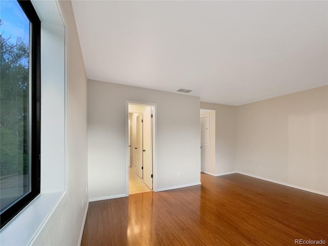 unfurnished room featuring hardwood / wood-style floors