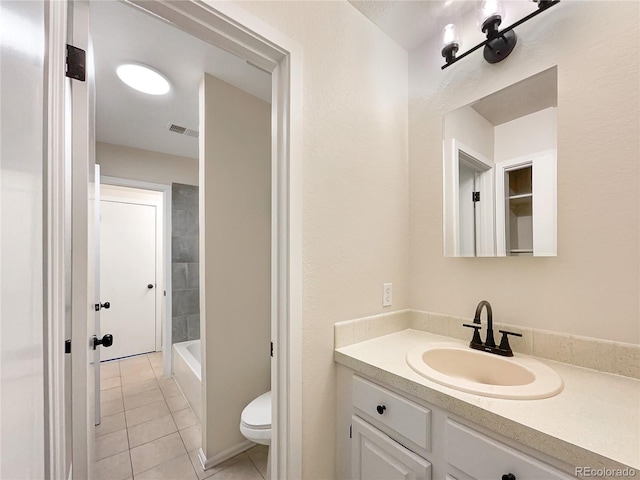 bathroom with tile patterned floors, vanity, and toilet