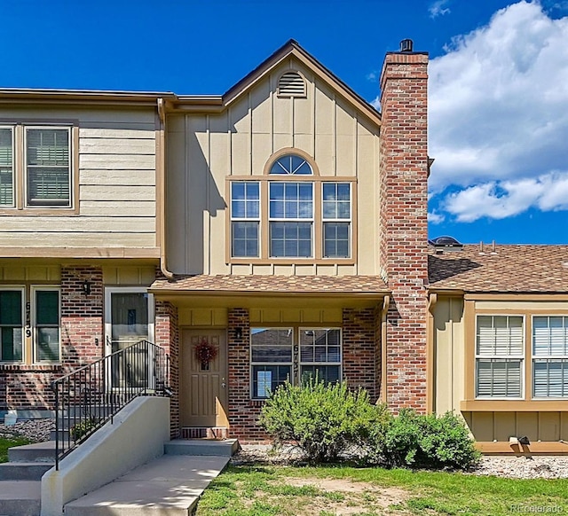 6737 Overland Dr, Colorado Springs, CO 80919 - view of front of property with board and batten siding, brick siding, and a chimney