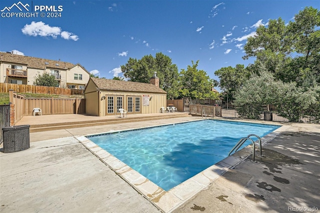6737 Overland Dr, Colorado Springs, CO 80919 - view of swimming pool with fence, a patio, a fenced in pool, a deck, and french doors