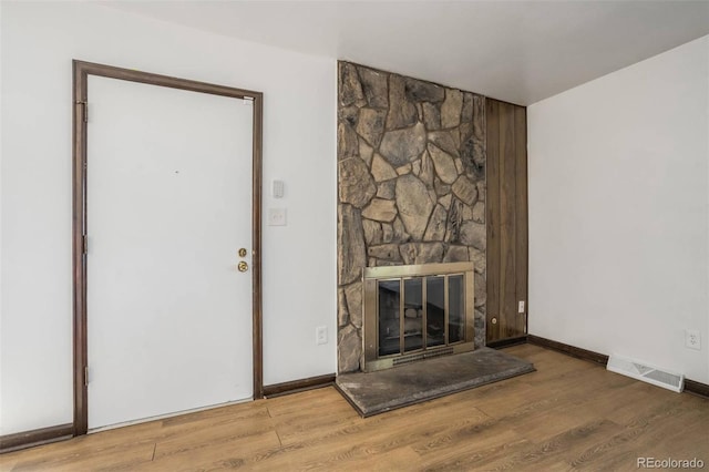 15157 E Louisiana Dr Unit A, Aurora, CO 80012 - unfurnished living room featuring wood finished floors and a fireplace