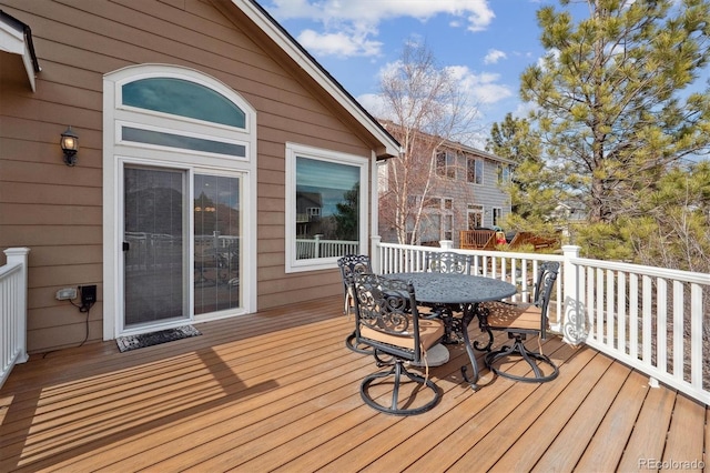 deck with outdoor dining area