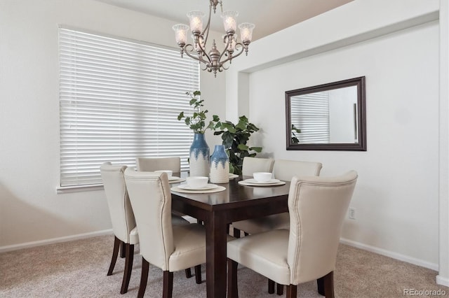 dining space featuring an inviting chandelier, baseboards, and carpet flooring