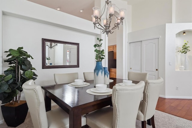 dining space with a chandelier and wood finished floors