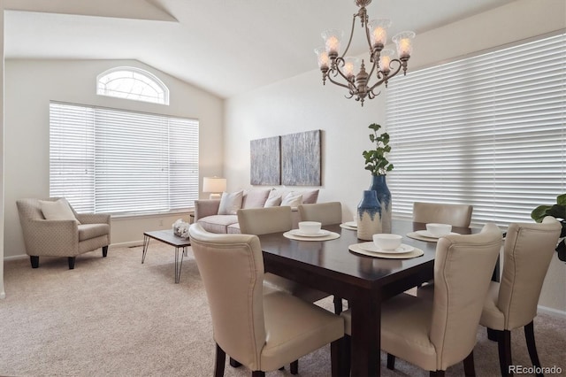 dining space featuring light carpet, baseboards, a chandelier, and lofted ceiling