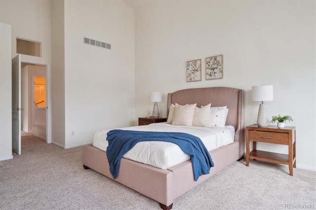 bedroom with baseboards, visible vents, a towering ceiling, and carpet flooring