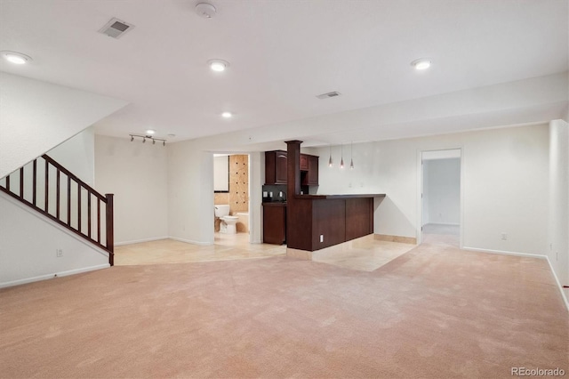 kitchen featuring recessed lighting, light colored carpet, visible vents, open floor plan, and a peninsula