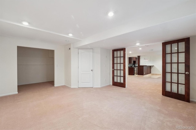 unfurnished room with recessed lighting, baseboards, light colored carpet, and french doors