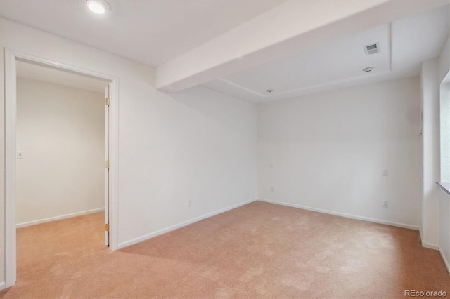 spare room with visible vents, light carpet, and baseboards