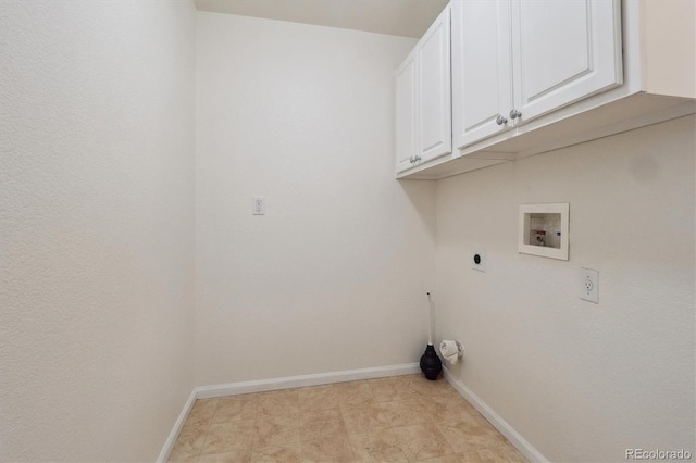 washroom with baseboards, hookup for a washing machine, cabinet space, and hookup for an electric dryer