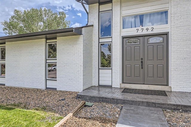 7792 Garrison Ct, Arvada, CO 80005 - doorway to property featuring brick siding