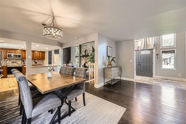 7792 Garrison Ct, Arvada, CO 80005 - dining room with plenty of natural light, a chandelier, baseboards, wood finished floors, and recessed lighting