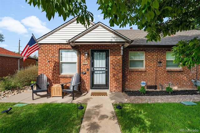 bungalow-style home with a patio area and a front yard