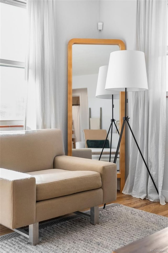 sitting room featuring hardwood / wood-style flooring and a healthy amount of sunlight