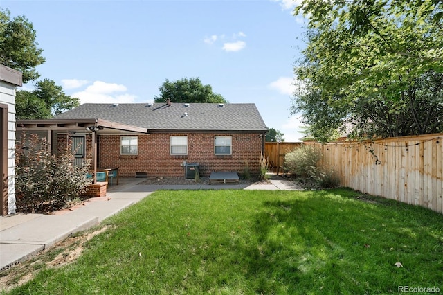 rear view of property featuring a lawn