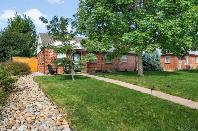 ranch-style home featuring a front yard