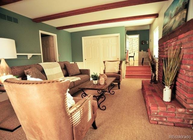 carpeted living room featuring visible vents and beamed ceiling