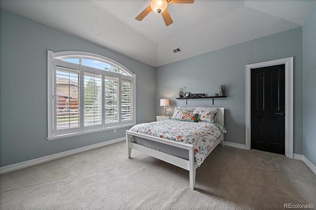 bedroom with lofted ceiling, carpet, visible vents, and multiple windows