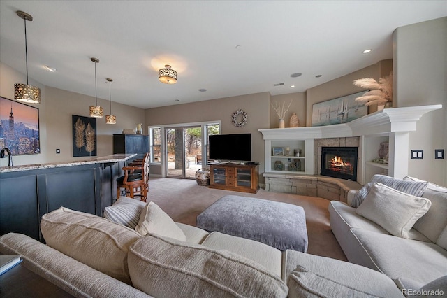 living area with a tiled fireplace, carpet floors, indoor bar, visible vents, and recessed lighting