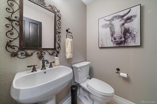 bathroom featuring a sink and toilet