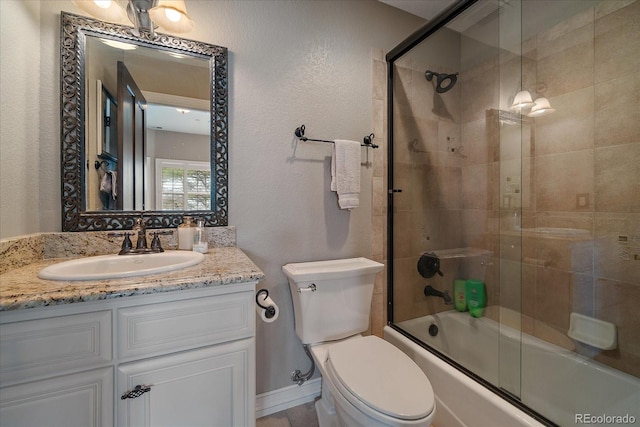 full bath featuring vanity, toilet, and bath / shower combo with glass door