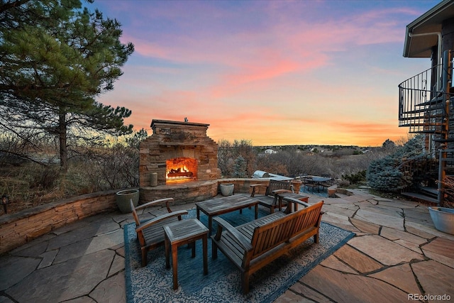view of patio with an outdoor stone fireplace