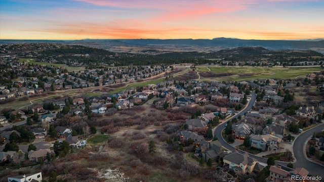 aerial view at dusk featuring a residential view and a mountain view