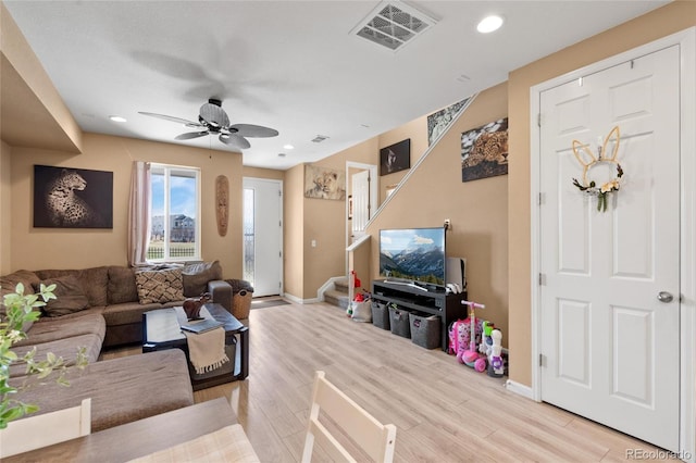 23584 E 5th Pl, Aurora, CO 80018 - living area with light wood-style floors, visible vents, baseboards, and stairway