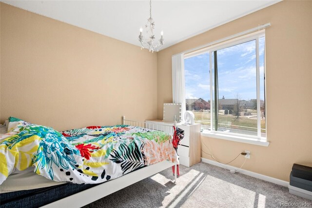 23584 E 5th Pl, Aurora, CO 80018 - bedroom featuring baseboards, light carpet, and a notable chandelier