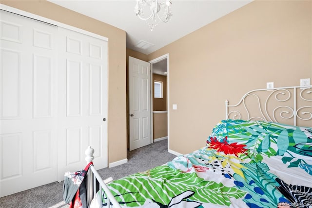 23584 E 5th Pl, Aurora, CO 80018 - bedroom featuring baseboards, carpet floors, a closet, and a notable chandelier