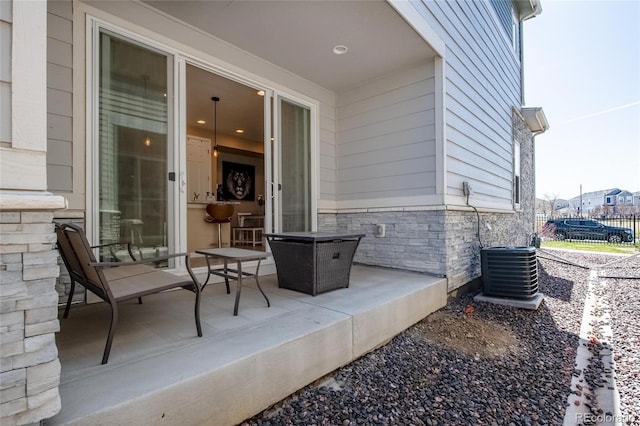 23584 E 5th Pl, Aurora, CO 80018 - view of patio / terrace with central AC unit and fence