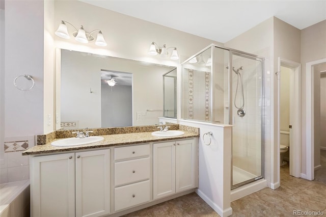 full bathroom featuring a sink, toilet, and a stall shower