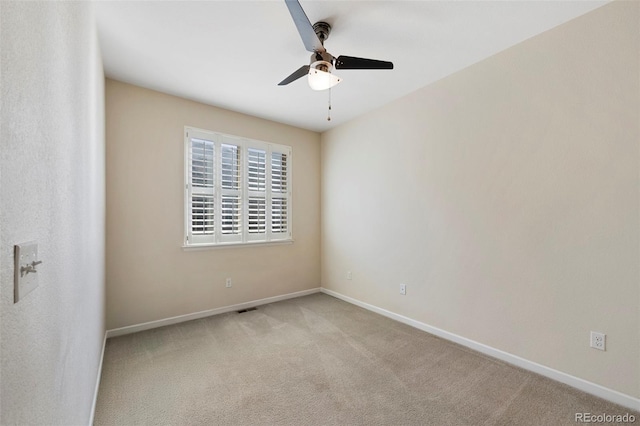 empty room with visible vents, a ceiling fan, baseboards, and carpet floors