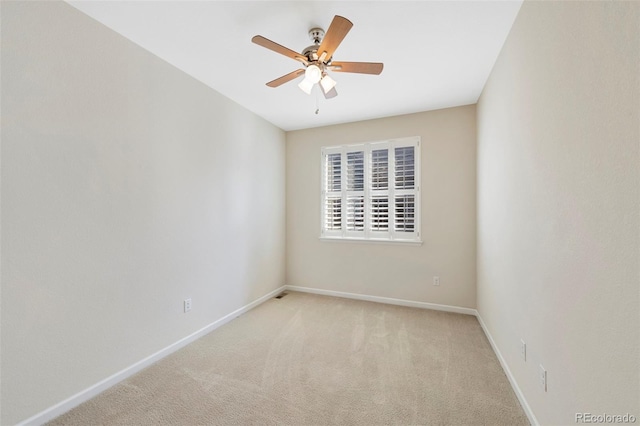 empty room featuring baseboards, carpet floors, and ceiling fan