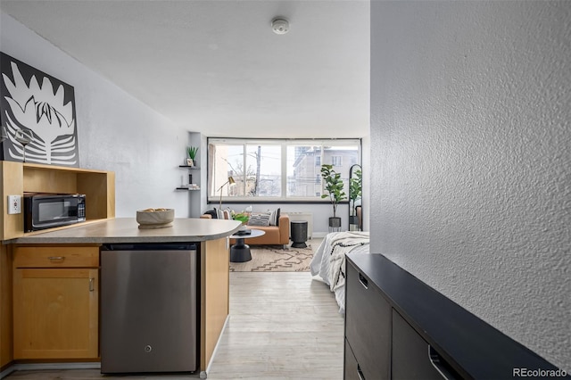 kitchen featuring fridge and light hardwood / wood-style floors