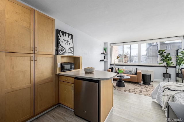 kitchen featuring kitchen peninsula, refrigerator, and light hardwood / wood-style floors