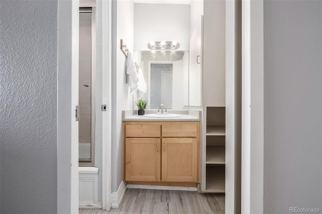 bathroom with vanity and hardwood / wood-style flooring