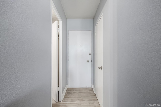 hallway with light wood-type flooring