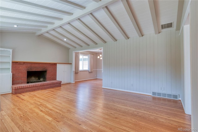815 Hoyt St, Lakewood, CO 80215 - unfurnished living room with wood finished floors and a brick fireplace