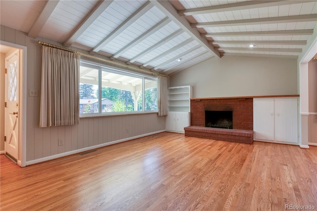 815 Hoyt St, Lakewood, CO 80215 - unfurnished living room featuring wood finished floors and a brick fireplace