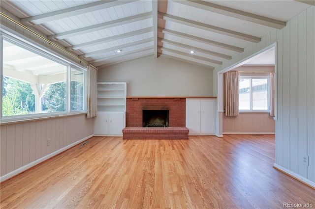 815 Hoyt St, Lakewood, CO 80215 - unfurnished living room with light wood-style flooring, a fireplace, and wooden walls
