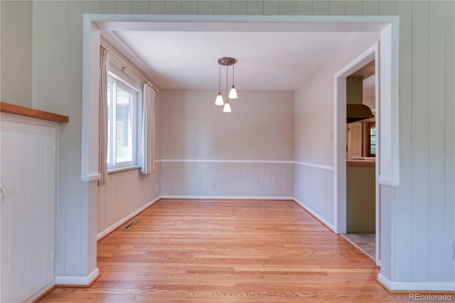 815 Hoyt St, Lakewood, CO 80215 - unfurnished dining area with light wood-style floors and baseboards
