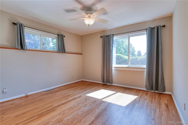 815 Hoyt St, Lakewood, CO 80215 - empty room with healthy amount of natural light, wood finished floors, and ceiling fan