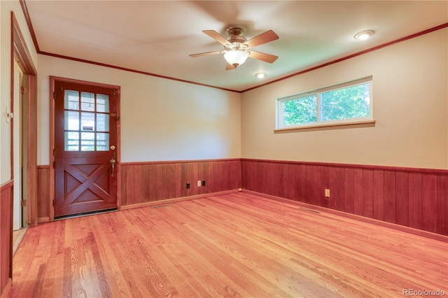 815 Hoyt St, Lakewood, CO 80215 - empty room featuring wood finished floors, wainscoting, a ceiling fan, ornamental molding, and wooden walls